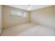 Clean, spacious bedroom with neutral carpeting and a large window providing ample natural light at 2192 Swedish Dr # 26, Clearwater, FL 33763