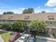 Well-maintained condominium exterior with mature trees, landscaping, and ample parking at 2192 Swedish Dr # 26, Clearwater, FL 33763