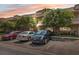 Exterior view of condo building featuring brick facade, mature trees, and parking spaces at 2192 Swedish Dr # 26, Clearwater, FL 33763