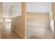 Hallway leading to the living room with laminate floors and neutral paint at 2192 Swedish Dr # 26, Clearwater, FL 33763
