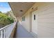 Hallway showing exterior access with the unit number 26 and a partial landscaped view at 2192 Swedish Dr # 26, Clearwater, FL 33763