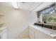 Functional laundry room with washer, dryer, built-in shelves, and ample workspace at 2192 Swedish Dr # 26, Clearwater, FL 33763