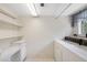 Functional laundry room with washer, dryer, built-in shelves, and ample workspace at 2192 Swedish Dr # 26, Clearwater, FL 33763