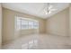 Bright living room featuring a bay window with plantation shutters and tiled flooring at 2192 Swedish Dr # 26, Clearwater, FL 33763
