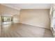 Spacious living room with laminate floors, large windows, and neutral walls at 2192 Swedish Dr # 26, Clearwater, FL 33763