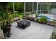 A wooden deck with planter boxes, a fire pit, and a screened pool beyond at 25435 Bruford Blvd, Land O Lakes, FL 34639