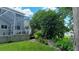 The beautiful backyard has grass and a covered patio area, and lots of foliage at 25435 Bruford Blvd, Land O Lakes, FL 34639