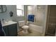 Bright bathroom featuring a modern sink, toilet, and a tub with sliding glass shower door at 25435 Bruford Blvd, Land O Lakes, FL 34639