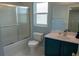 Bathroom features a shower with glass door and a vanity with modern fixtures at 25435 Bruford Blvd, Land O Lakes, FL 34639