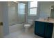 Bathroom features a shower with glass door and a vanity with modern fixtures and a toilet at 25435 Bruford Blvd, Land O Lakes, FL 34639