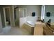 A bathroom with a bathtub and shower, and white tiled floor at 25435 Bruford Blvd, Land O Lakes, FL 34639