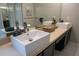 Bathroom featuring double sinks with designer fixtures and mirrors at 25435 Bruford Blvd, Land O Lakes, FL 34639