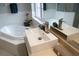 Bathroom with a large soaking tub, modern sink and vanity with attractive faucet at 25435 Bruford Blvd, Land O Lakes, FL 34639