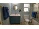Bathroom with a modern sink, toilet, and a bathtub with shower and sliding glass door at 25435 Bruford Blvd, Land O Lakes, FL 34639