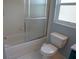 Bathroom features a shower with glass door, a toilet and a window to let the light in at 25435 Bruford Blvd, Land O Lakes, FL 34639