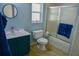 Bright bathroom featuring modern sink, toilet, and tub with sliding glass door at 25435 Bruford Blvd, Land O Lakes, FL 34639
