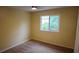 Cozy bedroom with neutral walls and carpeted floors, well-lit by a window at 25435 Bruford Blvd, Land O Lakes, FL 34639