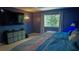 Bedroom with a king-sized bed, TV and large window at 25435 Bruford Blvd, Land O Lakes, FL 34639