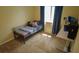 Bedroom with large window, desk, and comfortable bed for relaxing or working at 25435 Bruford Blvd, Land O Lakes, FL 34639