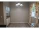 A dining area with a chandelier, window, and neutral-toned decor at 25435 Bruford Blvd, Land O Lakes, FL 34639