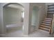 Open foyer with gray tile flooring, archways, and a view of the staircase and living area at 25435 Bruford Blvd, Land O Lakes, FL 34639