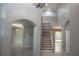Foyer with a staircase featuring built-in shelving, open archways, and views into adjacent living spaces at 25435 Bruford Blvd, Land O Lakes, FL 34639