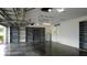 Spacious garage with finished floor, interior access door, and ceiling fans at 25435 Bruford Blvd, Land O Lakes, FL 34639