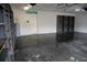 Spacious garage with finished floor, shelving, and a door to the interior at 25435 Bruford Blvd, Land O Lakes, FL 34639