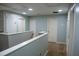 Hallway upstairs with neutral carpet and light blue walls at 25435 Bruford Blvd, Land O Lakes, FL 34639