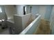 Hallway upstairs with multiple doors, white trim, and neutral carpet at 25435 Bruford Blvd, Land O Lakes, FL 34639