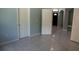 Hallway with tile flooring leading to front entry, other rooms, and arched doorways at 25435 Bruford Blvd, Land O Lakes, FL 34639