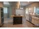 A full kitchen view with a black island, farm sink, and stainless steel appliances at 25435 Bruford Blvd, Land O Lakes, FL 34639