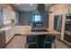 A full kitchen view with stainless steel appliances, white cabinets, and a black kitchen island at 25435 Bruford Blvd, Land O Lakes, FL 34639