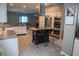 A full kitchen view with stainless steel appliances and a black kitchen island at 25435 Bruford Blvd, Land O Lakes, FL 34639