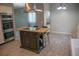 Modern island kitchen features wood top, stainless vent hood and stainless appliances at 25435 Bruford Blvd, Land O Lakes, FL 34639