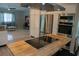 A kitchen featuring stainless steel appliances, white cabinets, and butcher block island with seating at 25435 Bruford Blvd, Land O Lakes, FL 34639