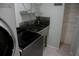 Laundry room with stainless steel utility sink and modern appliances at 25435 Bruford Blvd, Land O Lakes, FL 34639
