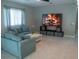 Spacious living room features a cozy fireplace display and natural light at 25435 Bruford Blvd, Land O Lakes, FL 34639
