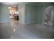 Spacious living room with tile flooring, open floor plan, and view into kitchen area at 25435 Bruford Blvd, Land O Lakes, FL 34639
