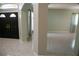 Open living area with tile flooring, neutral paint, and views of the front entrance at 25435 Bruford Blvd, Land O Lakes, FL 34639