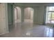 Open living area featuring neutral paint, tile floors, and arched doorways at 25435 Bruford Blvd, Land O Lakes, FL 34639