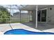 Screened-in pool with a covered lanai and sliding glass doors for easy indoor-outdoor living at 25435 Bruford Blvd, Land O Lakes, FL 34639