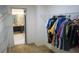 Walk-in closet featuring wire shelving with bathroom in the background at 25435 Bruford Blvd, Land O Lakes, FL 34639