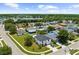 An aerial view of a neighborhood with well-maintained lawns and a scenic lake in the background, showing curb appeal at 2746 Heathgate Way, Land O Lakes, FL 34638