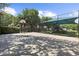 A fenced basketball court adjoins a playground with canopy cover; picnic tables and lush greenery create a fun, active space at 2746 Heathgate Way, Land O Lakes, FL 34638