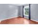 Bedroom featuring gray walls, hardwood floors, and large window bringing in natural light at 2746 Heathgate Way, Land O Lakes, FL 34638