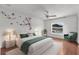 This is a staged bedroom featuring a bed with white bedding, and a green throw blanket and pillows at 2746 Heathgate Way, Land O Lakes, FL 34638
