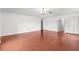 Spacious bedroom with wood floors and a decorative chandelier at 2746 Heathgate Way, Land O Lakes, FL 34638
