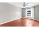 Bedroom featuring gray walls, ceiling fan, and a window with white curtains at 2746 Heathgate Way, Land O Lakes, FL 34638