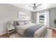 Bedroom featuring gray walls, ceiling fan, and large window with white curtains at 2746 Heathgate Way, Land O Lakes, FL 34638